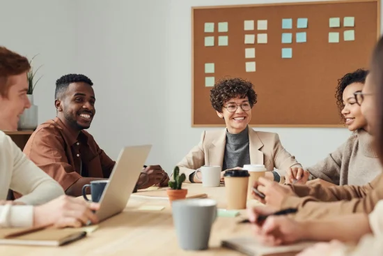Small group meeting around a table in an office